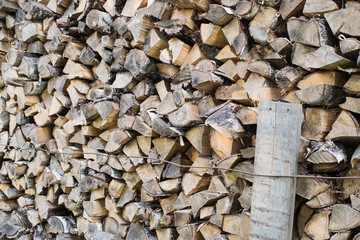 Fototapeta premium background of chopped wood stacked in a row and tied with wire