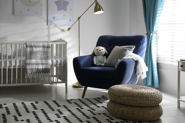 Cozy baby room interior with comfortable armchair