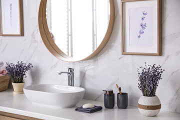 Mirror and counter with vessel sink in stylish bathroom interior. Idea for design