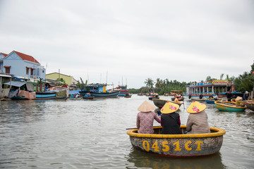 Fototapeta na wymiar HOI AN,VIETNAM-December 9,2019: Tourists enjoy round basket boat Made of bamboo is a unique Vietnamese at Cam thanh village.