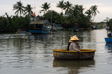 HOI AN,VIETNAM-December 9,2019: Tourists enjoy round basket boat Made of bamboo is a unique Vietnamese at Cam thanh village.