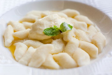 Lazy dumplings - vareniki of cottage cheese on a white plate, close up on a white plate