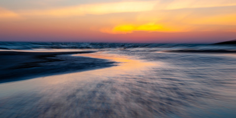 Abstract seascape at sunset. Motion blur with a long exposure.
