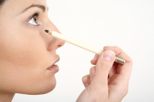 Woman Applying Eyeliner