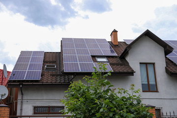 House with installed solar panels on roof. Alternative energy source