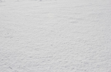 Texture of fresh snow covering the ground in winter .