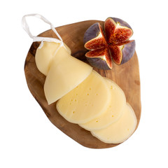 Cheese with figs on wooden board isolated on white. Cheese plate. Scamorza Italian semi-soft white...