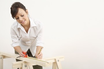 Woman measuring wood