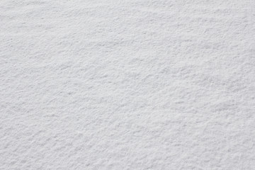 Texture of fresh snow covering the ground in winter .