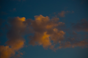 close-up cumulus clouds on the background of the setting sun