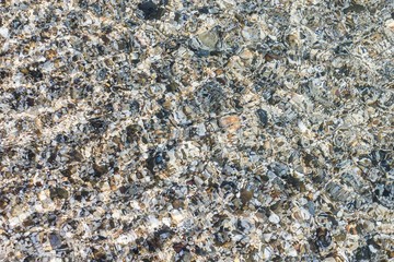 sea pebbles in the water, ripples on the water