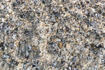 sea pebbles in the water, ripples on the water, relax