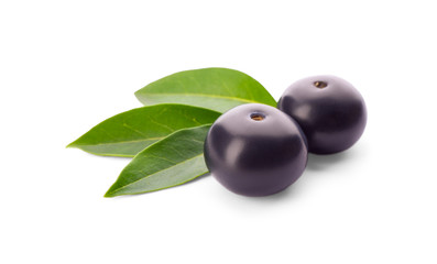 Fresh acai berries with leaves isolated on white
