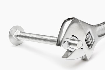 Crescent wrench tightening nut into bolt