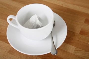 A cup with tea sachet in it