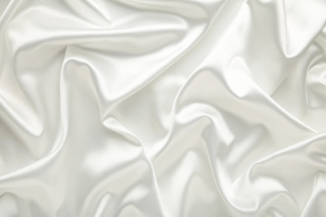 White satin fabric as a background. Top view