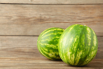 Two fresh watermelons on grey background with copy space