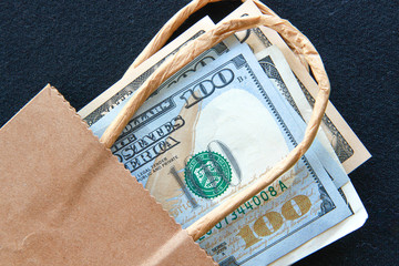 American notes and coins and a brown paper bag.
