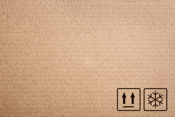 Cardboard box with packaging symbols as background, closeup
