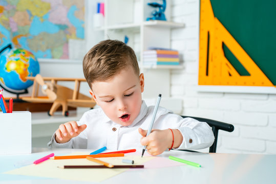 Cute Kid At Home Or Daycare. Child Studying From Home. Elementary School Learning And Kids Concept.