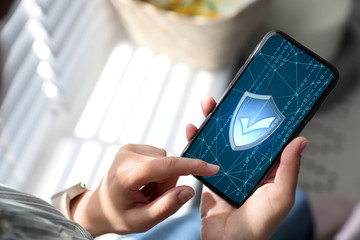 Cyber security concept. Woman using application on phone, closeup