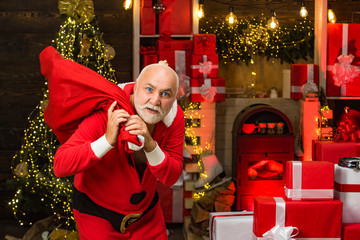Santa Claus thief with a bag of christmas gifts. Santa in the mask with bag. Rogue thief wearing...
