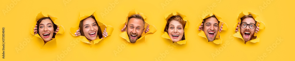 Wall mural excited people tearing yellow paper