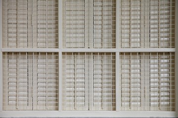 White wooden window with iron grid