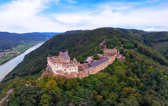 Beautiful landscape with Aggstein castle ruin and Danube river at sunset in Wachau walley Austria. Amazing historical ruins. Original german name is Burgruine aggstein. Little castle in english.