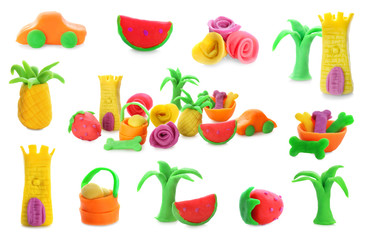 Collection of small figures made from play dough on white background