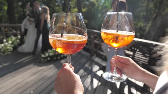 Glasses of Aperol in Hands of Waiter. Concept of Party, Wedding