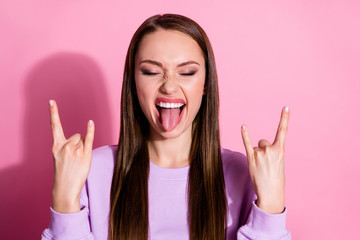 Closeup photo of funky cool youngster lady stick tongue out mouth showing fingers hands horns crazy...