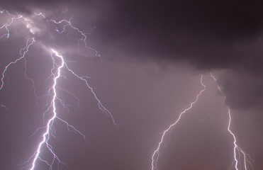 Fototapeta na wymiar Lightning in the sky at night as an background.