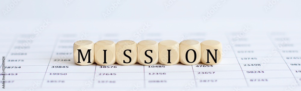 Poster text mission on a wooden cube blocks on the chart