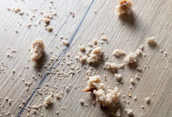 Bread crumbs on a wooden table.