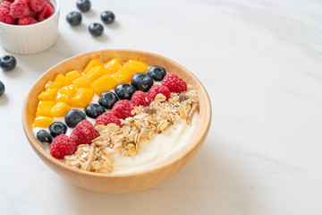 homemade yogurt bowl with raspberry, blueberry, mango and granola