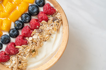 homemade yogurt bowl with raspberry, blueberry, mango and granola