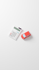 A photo-realistic CG illustration of a car toy and a calculator on a plane.