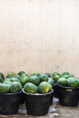 Watermelons in a market in Singapore with negative space
