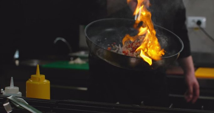 Pan Flame Fire Chef Cooking Food in Restaurant Big Flames in Slow Motion Close Up