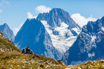 Fototapeta premium People sit on the background of mountains
