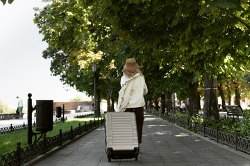 tourist woman with a suitcase down the street in a European city, tourism in Europe. goes down the street.