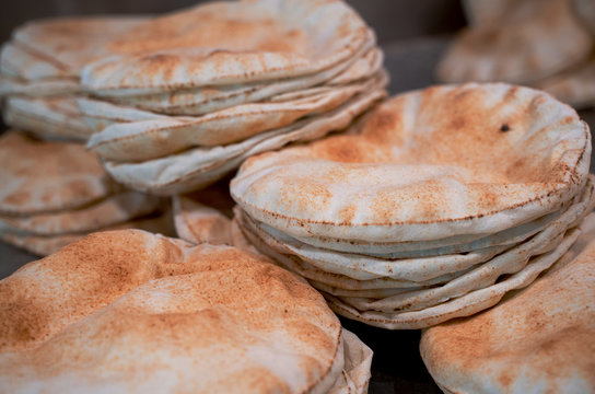 Kuboos or khubz - fresh pita bread togeather in a table