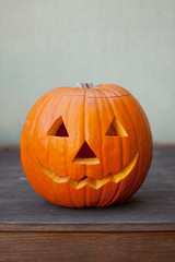 Halloween pumpkin head jack lantern on wooden background