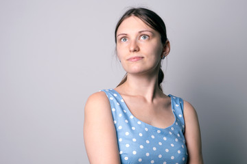 young girl in a blue dress with a pony tail in studio