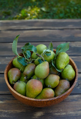 fresh pears in a wooden bowl