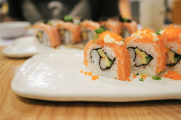 Salmon rolls sushi on white plate