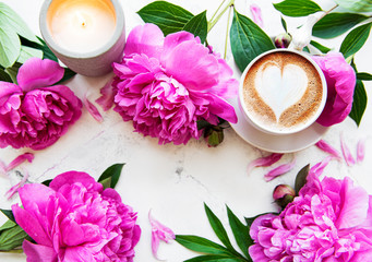 Fototapeta na wymiar Pink peony flowers and cup of coffee