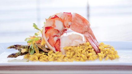 Shrimp Cream Sauce With Asparagus And Yellow Rice With The Sea As Background.