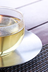 Hot Green Tea On Transparent Cup And Metal Saucer.